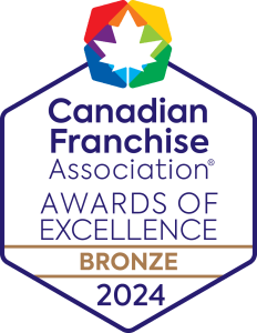 Logo of the Canadian Franchise Association's Awards of Excellence 2024, with a multicolored hexagon and maple leaf, indicating a Bronze level achievement.